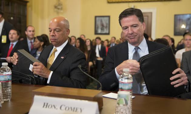 FBI Director James Comey right and Homeland Security Secretary Jeh Johnson prepare to testify on Capitol Hill in Washington Thursday