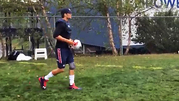 Tom Brady walks to the practice field on Friday