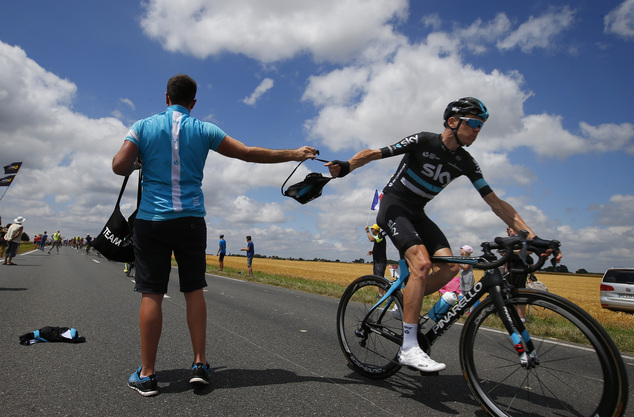 Britain¿s Chris Froom grabs a bag with food from a team member in the feeding zone during the fourth stage of the Tour de France cycling race over 237.5 kilo