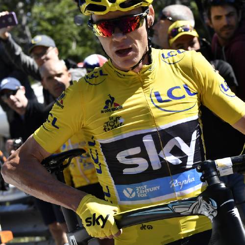 Froome wearing the overall leader's yellow jersey runs with his bike after a crash at the end of the twelfth stage of the Tour de France cycling race with start in Montpellier and finish six kilometers before