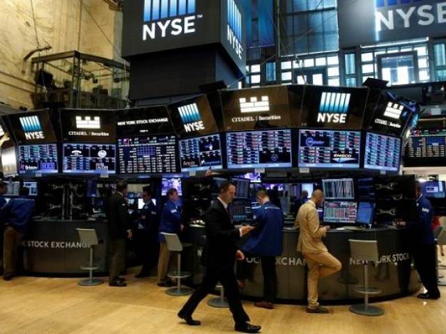 Traders work at the Citadel Securities post on the floor of the New York Stock Exchange