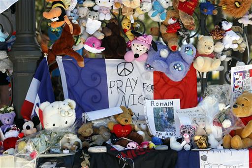 Dolls and teddy bears are placed at a memorial in a gazebo on the Promenade des Anglais in Nice southern France Wednesday