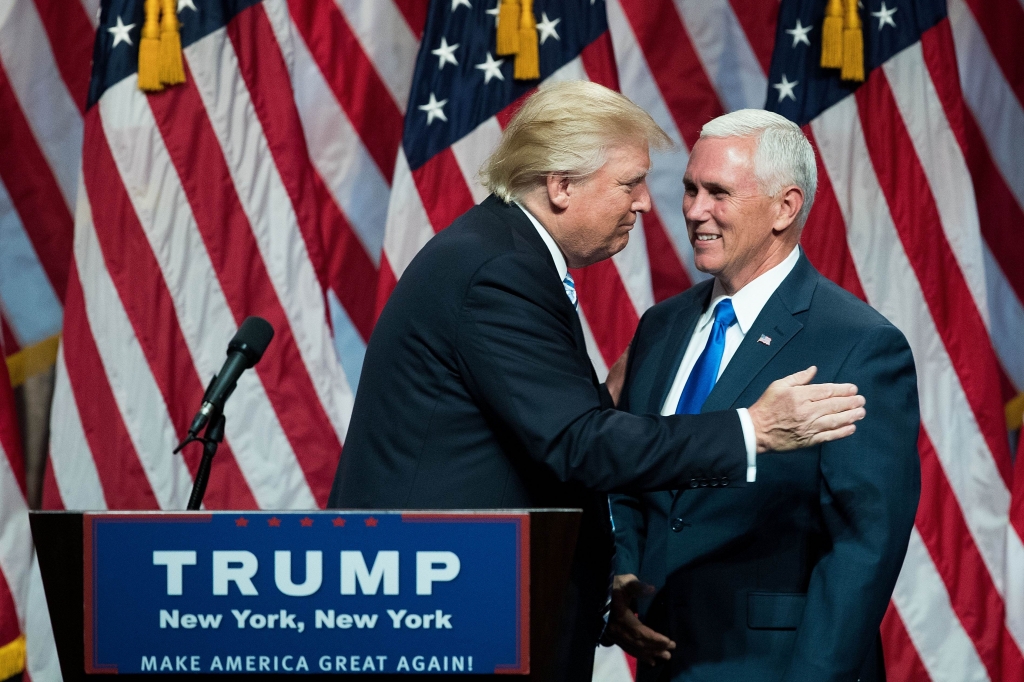 Indiana Gov. Mike Pence joins Republican presidential candidate Donald Trump at a rally in Westfield Ind. on July 12. Pence's decision to join Trump on the ticket is at odds with his previous positions