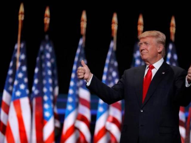 Republican US presidential nominee Donald Trump gives two thumbs up as he arrives to speak during the final session at the Republican National Convention in Cleveland Ohio US