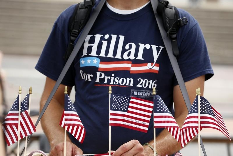 A supporter of Republican presidential candidate Donald Trump sells flags while wearing a'Hillary For Prison 2016 shirt at a pro Trump rally near the Republican National Convention in Cleveland Ohio