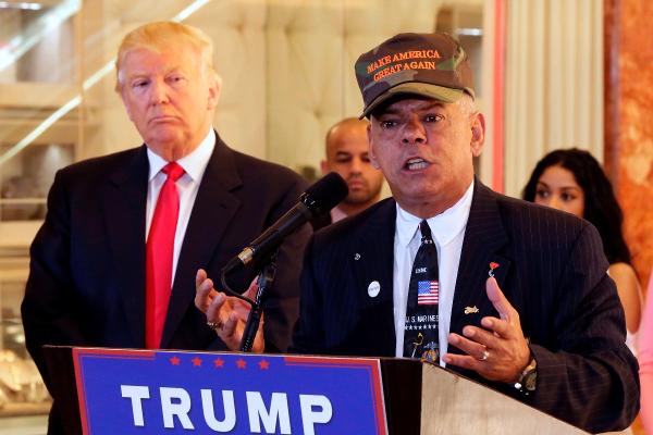 Republican presidential candidate Donald Trump listens at left as Al Baldasaro a New Hampshire state representative speaks during a news conference in New York