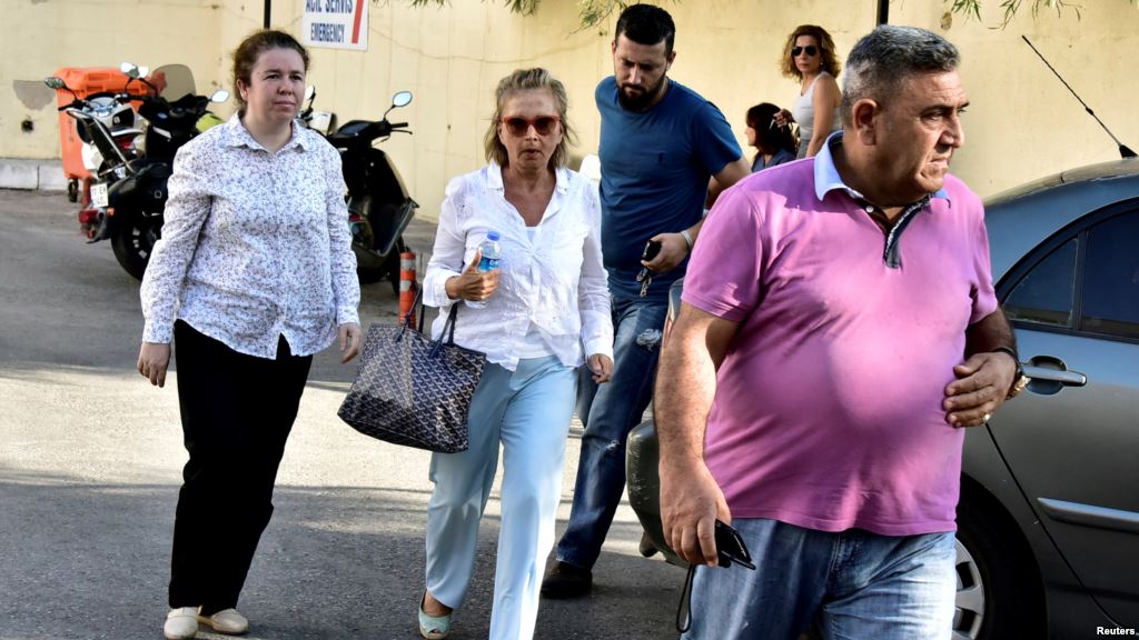 Turkish journalist Nazli Ilicak, a well-known commentator and former parliament deputy is escorted by a police officer and relatives after being detained in Bodrum days after the failed coup in Turkey on July 15