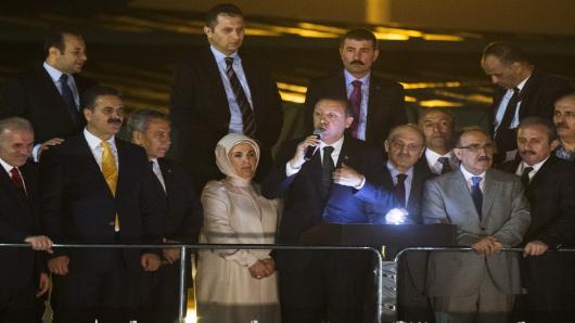 Turkish Prime Minister Recep Tayyip Erdogan speaks to thousands of his supporters who greeted the prime minister at Istanbul airport on his return from a North African tour