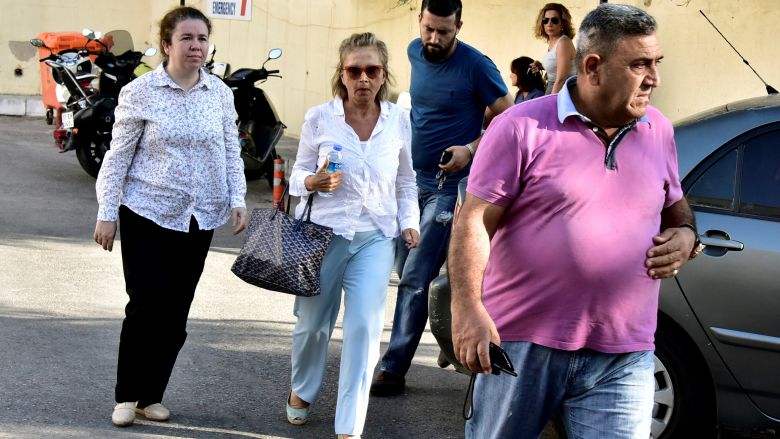 Turkish journalist Nazli Ilicak, also a well-known commentator and former parliamentarian is escorted by a police officer and her relatives after being detained and brought to a hospital for a medical check in Bodrum Turkey July 26