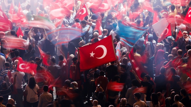 Supporters of Turkish President Tayyip Erdogan wave Turkish national flags during a pro-government demonstration on Taksim square in Istanbul on Tuesday