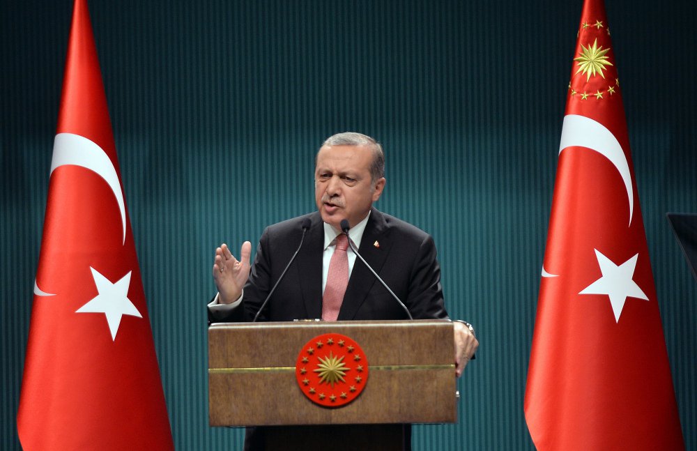 Turkey's President Recep Tayyip Erdogan speaks after an emergency meeting of the government in Ankara Turkey late Wednesday. Erdogan on Wednesday declared a three-month state of emergency following a botched coup attempt declaring he would rid the mili