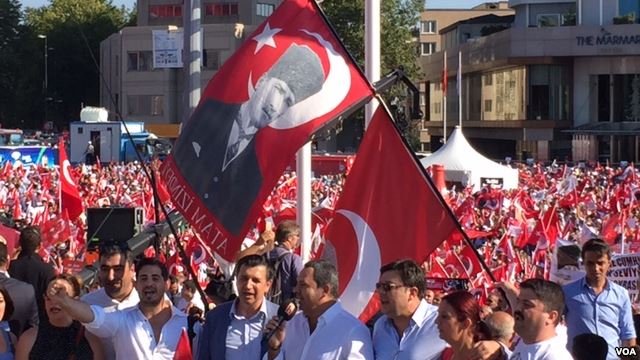 Demonstrators at Taksim Square wave flags bearing the face of Mustafa Kemal Ataturk revered as founder of the modern Turkish Republic