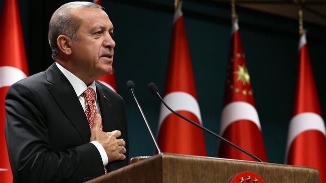 Turkish President Recep Tayyip Erdogan addresses people demonstrating a recent coup attempt via video conferencing at the Turkish Presidency in Ankara