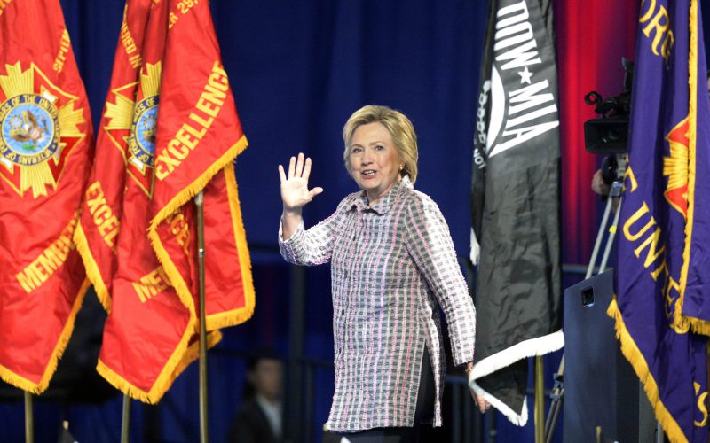 Hillary Clinton the presumptive Democratic presidential nominee waves to the crowd as she steps onstage to address the 117th annual VFW National Convention at the Charlotte Convention center on Monday