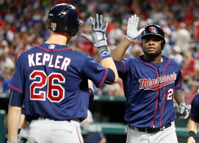 Minnesota Twins&#39 Miguel Sano celebrates his three-run home run with Max Kepler against the Texas Rangers during the fifth inning of a baseball game Friday