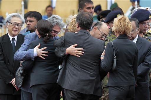 Foreign diplomats embrace each other as they attend a ceremony to offer tribute to the victims of the attack on Holey Artisan Bakery at a stadium in Dhaka Bangladesh Monday