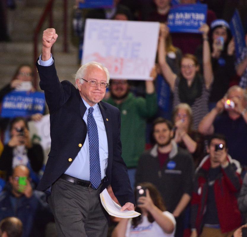 Bernie Sanders raises a fist as he walks to the stage Feb. 22 2016 at the Mullins Center