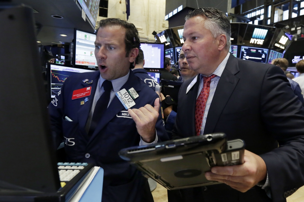 Specialist Mike Pistillo left and trader Mario Lagagna work on the floor of the New York Stock Exchange Wednesday