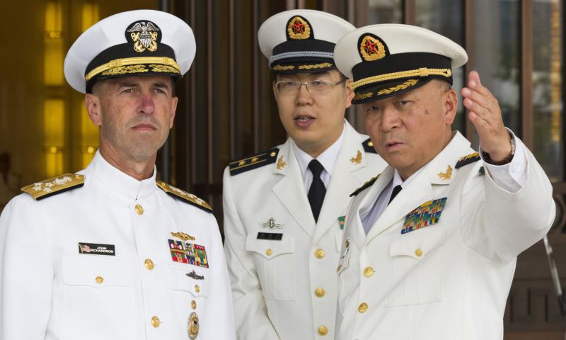 U.S. Chief of Naval Operations Adm. John Richardson listens to Commander of the Chinese Navy Adm. Wu Shengli right at the Chinese navy's headquarters in Beijing on Monday