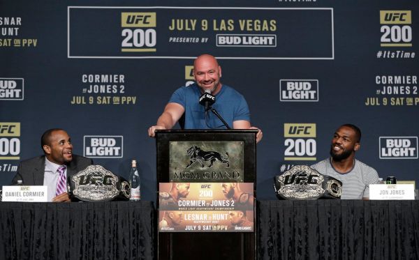 Dana White center stands between Daniel Cormier left