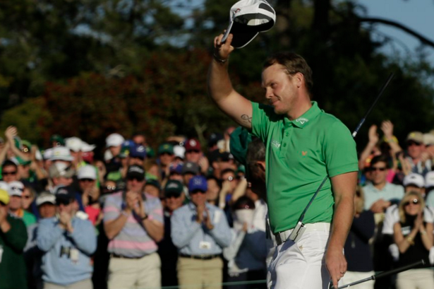 Danny Willett waves to the crowd after completing the 18th hole during the final round of The Masters