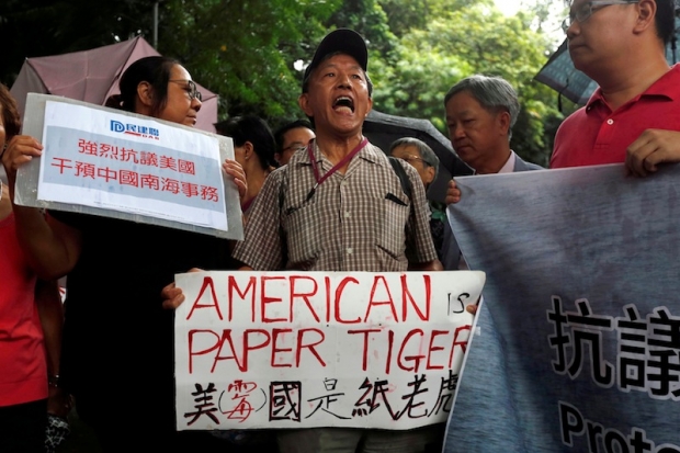 A protester from a local pro China party chants slogans against the United States supporting an international court ruling outside US Consulate in Hong Kong China