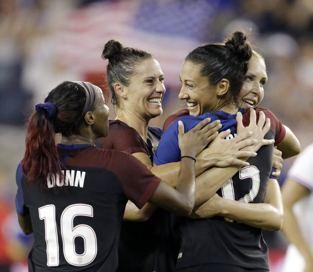 United States forward Christen Press second from right is congratulated by Crystal Dunn Kelley O'Hara second from left and Allie Long right after