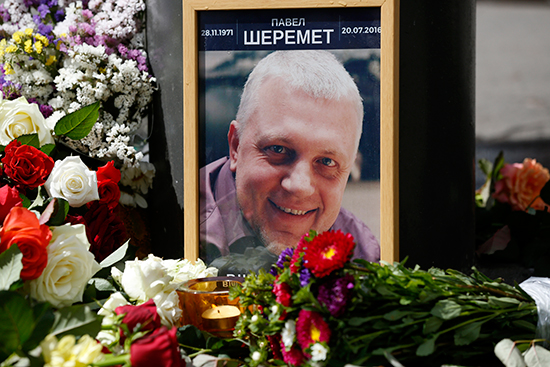 Flowers and a portrait of Pavel Sheremet mark the site of the journalist's murder in Kiev