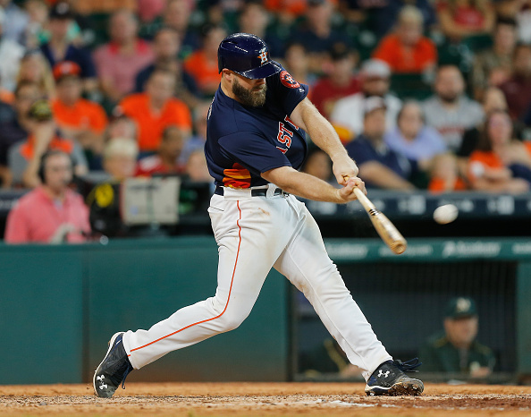 HOUSTON TX- JULY 10 Evan Gattis #11 of the Houston Astros doubles in the tieing run in the ninth inning against the Oakland Athletics at Minute Maid Park