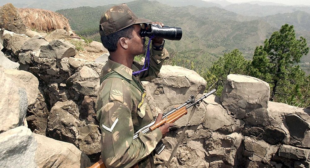 An Indian soldier looks through binoculars at a forward post somewhere in Mendhar sector 200 meters from the Line of Control separating Indian and Pakistan held Kashmir some 100 Kms southwest of Srinagar