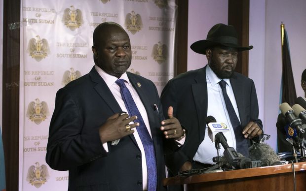 First Vice President Riek Machar delivers a speech to journalists next to South Sudan President Salva Kiir and Vice President James Wani Igga prior to the shooting outside the presidential palace in Juba