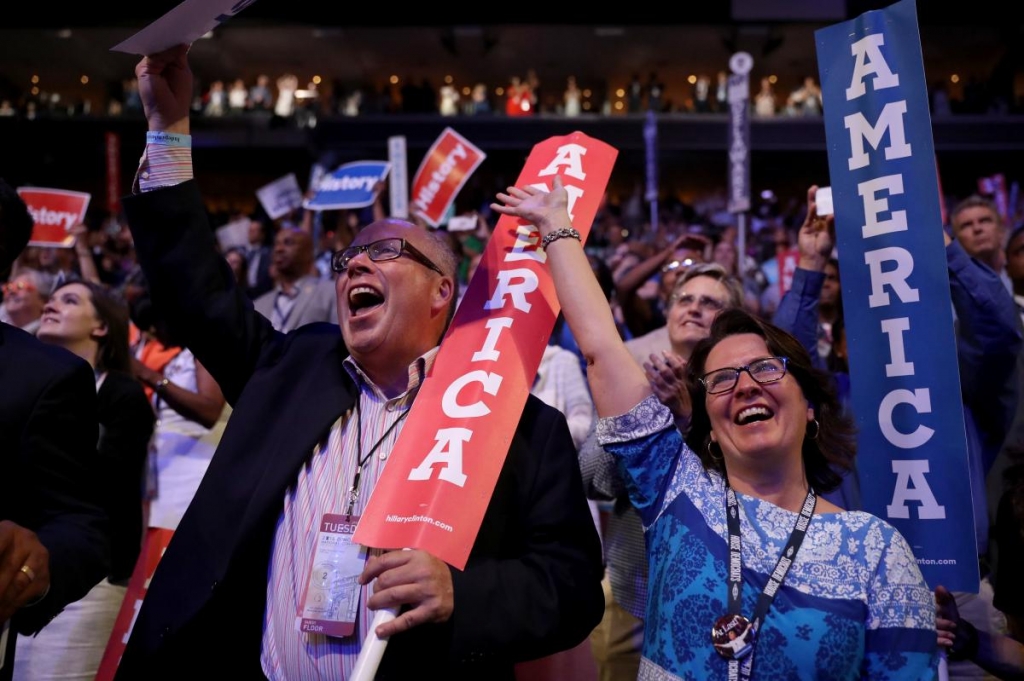 Delegates stand and cheer during the evening session on the second day of the Democratic National Convention