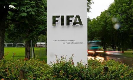 Cars drive past a logo in front of FIFA's headquarters in Zurich