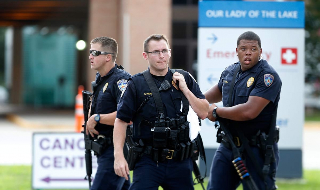 Police guard the emergency room entrance of Our Lady Of The Lake Medical Center where wounded officers were brought in Baton Rouge La. Sunday