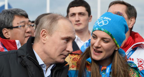 Russian President Vladimir Putin speaks with Olympic Village Mayor Elena Isinbaeva while visiting the Coastal Cluster Olympic Village ahead of the Sochi 2014 Winter Olympics in Sochi Russia. /AP