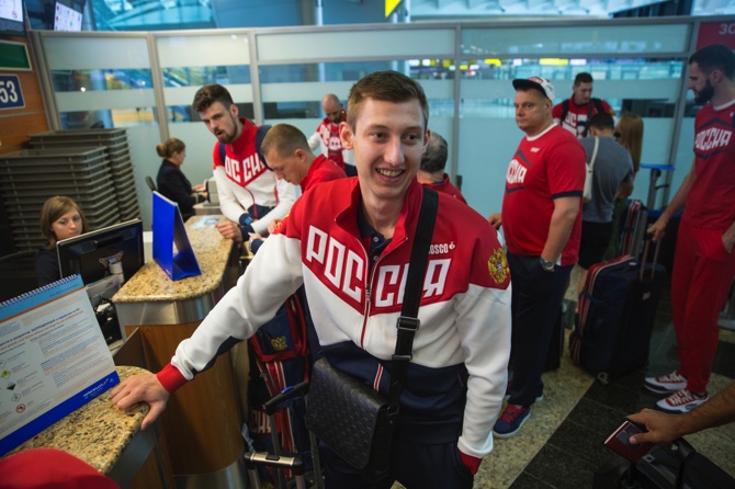 Volleyball player and Russia’s National Olympic team member Dmitrij Volkov wait at a check-in desk before his team’s departure for Rio Olympics