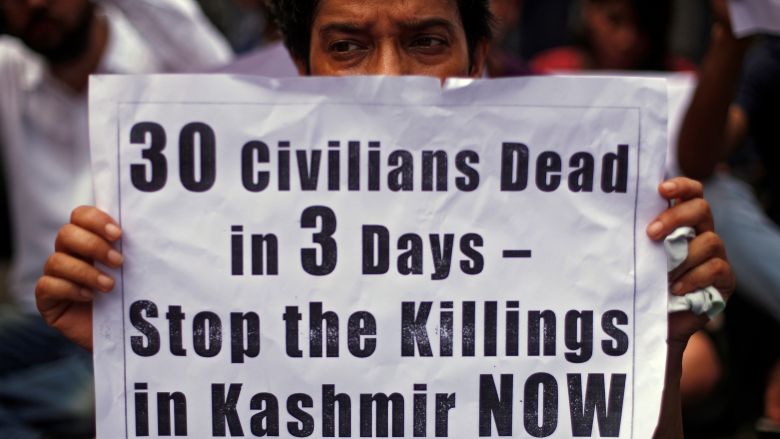 A woman holds a placard as she attends a protest against what they say are the recent killings of Kashmiri civilians in New Delhi India