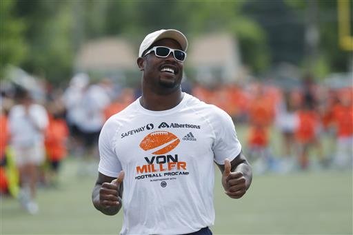 Denver Broncos linebacker Von Miller runs with participants as the Super Bowl 50 MVP hosts a football camp for kids on a high school field in Englewood Colo. Miller has agreed to a blockbuster 4.5 million contr