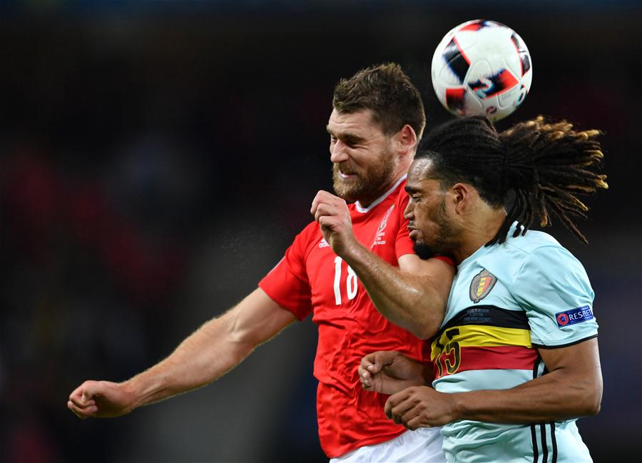 Sam Vokes of Wales vies with Jason Denayer of Belgium during the Euro 2016 quarterfinal match between Belgium and Wales in Lille France