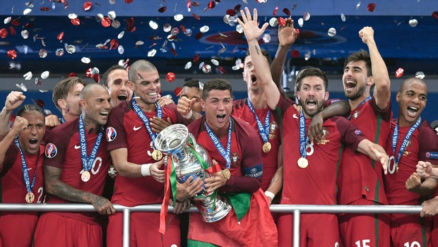 Portugal's Cristiano Ronaldo holds the trophy after winning the Euro 2016 final soccer match between Portugal and France at the Stade de France in Saint-Denis north of Paris Sunday