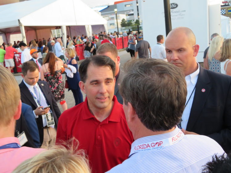 Wisconsin Gov. Scott Walker greets attendees at the opening bash of the Republican National Convention in Cleveland