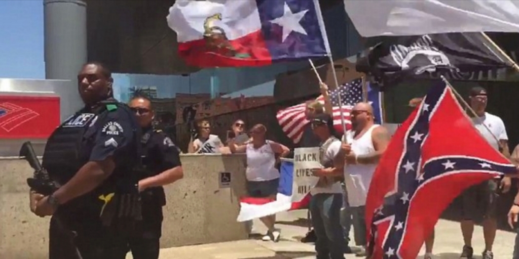 Watch Calm Black Police Officer Stands Guard for Hateful White Lives Matter Protests    Here's what happened when an opposing group showed