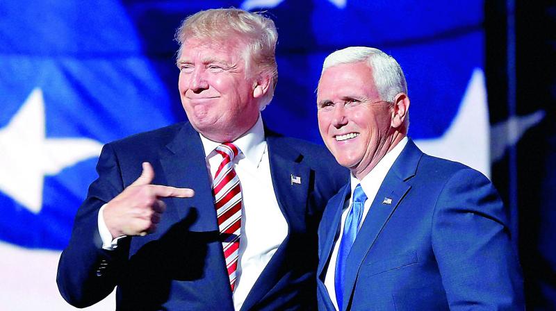 Republican presidential candidate Donald Trump points toward Republican vice-presidential candidate Indiana Gov. Mike Pence after his acceptance speech in Cleveland on Wednesday