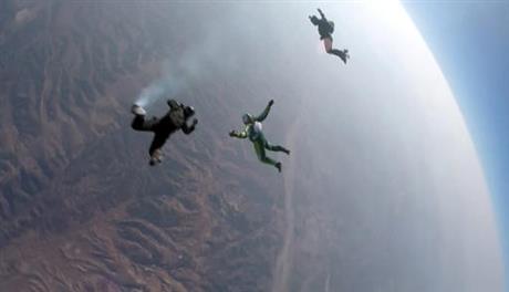 In this image made from a video provided by Mondelez International Luke Aikins center skydives without a parachute over Simi Valley Calif. Saturday