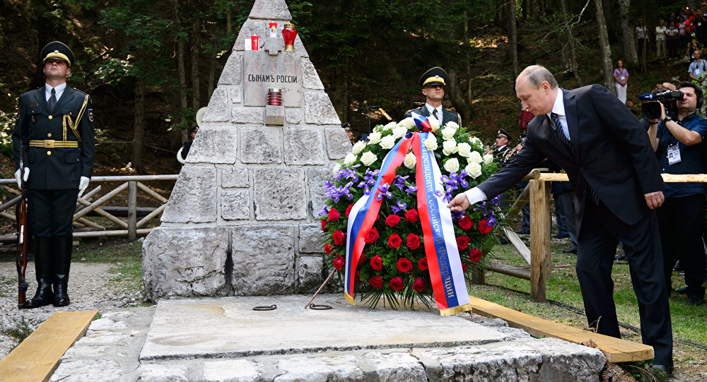 Russian President Vladimir Putin lays a wreath during a ceremony at a Russian Chapel at the Vrsic mountain pass in northern Slovenia