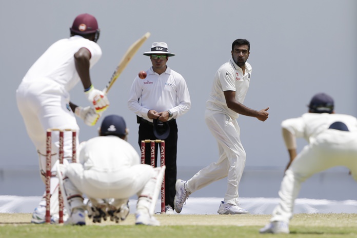 India's Ravichandran Ashwin right bowls against West Indies during day four of their first cricket Test match at the Sir Vivian Richards Stadium in North Sound Antigua Sunday July 24. Ashwin took seven wickets