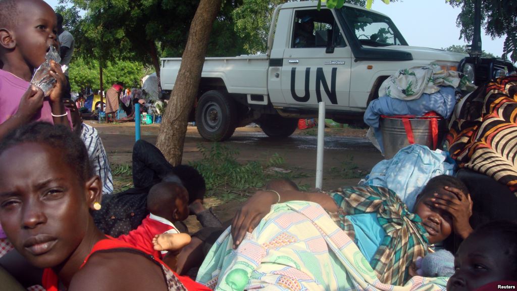 FILE- South Sudanese families rest in a camp for internally displaced people at the United Nations mission compound in Tomping Juba