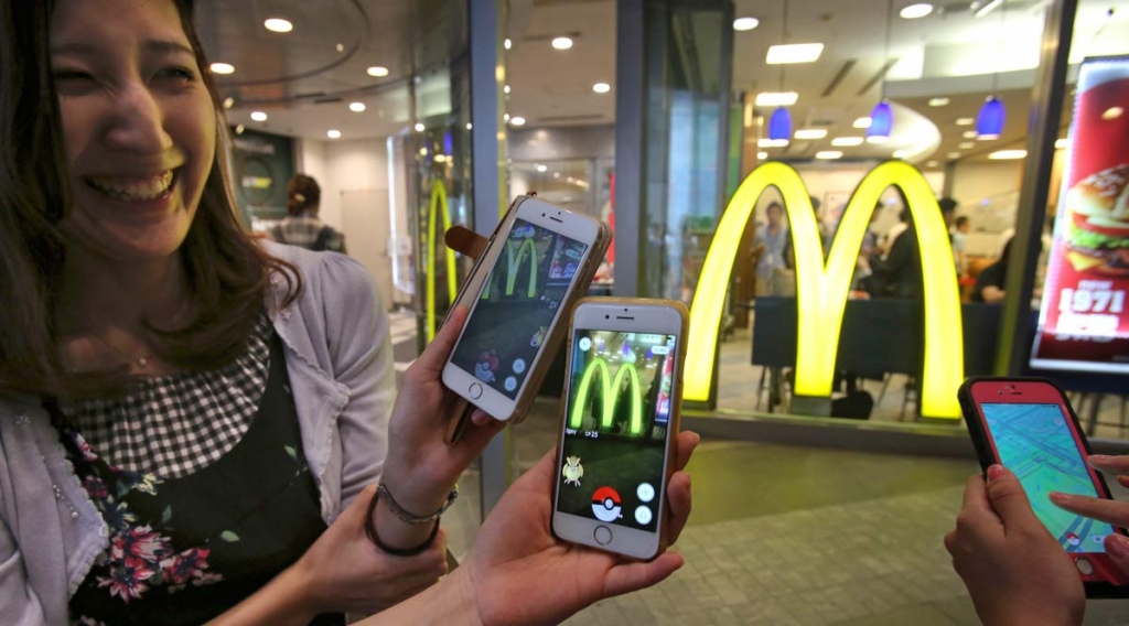 Women play'Pokemon Go in front of a McDonald's restaurant in Tokyo Friday