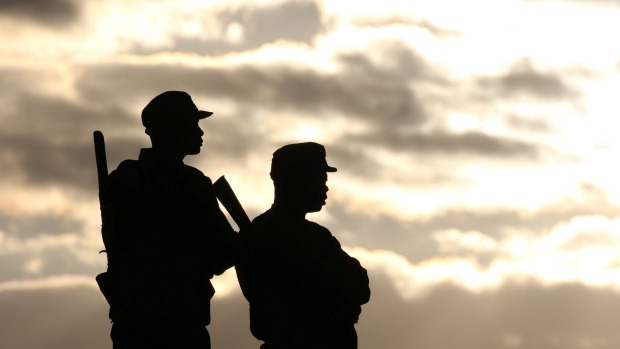 Police officers stand guard during a political rally addressed by Zimbabwe President Robert Mugabe in Bindura north