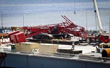 A giant construction crane toppled off the new Tappan Zee Bridge being constructed north of New York City and collapsed across the busy span it is replacing